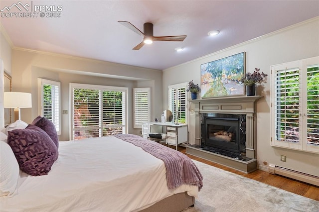 155 Grayson Ct, Colorado Springs, CO 80906 - bedroom featuring ornamental molding, wood finished floors, a high end fireplace, multiple windows, and baseboard heating