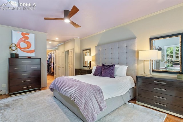 155 Grayson Ct, Colorado Springs, CO 80906 - bedroom with ornamental molding, a spacious closet, wood finished floors, a closet, and a ceiling fan