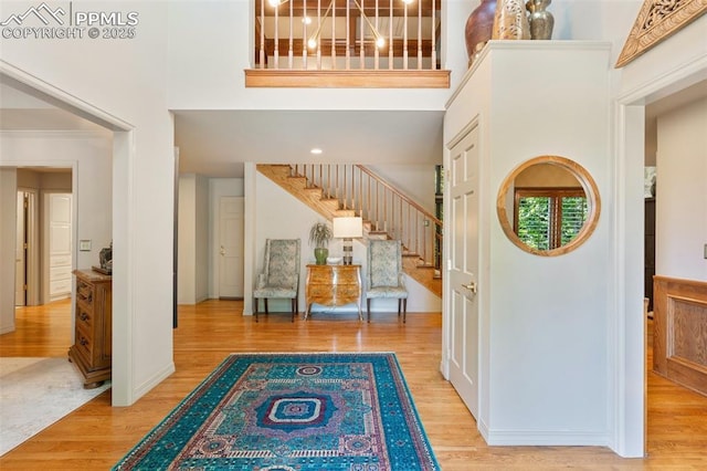 155 Grayson Ct, Colorado Springs, CO 80906 - foyer entrance featuring stairs, a high ceiling, and wood finished floors