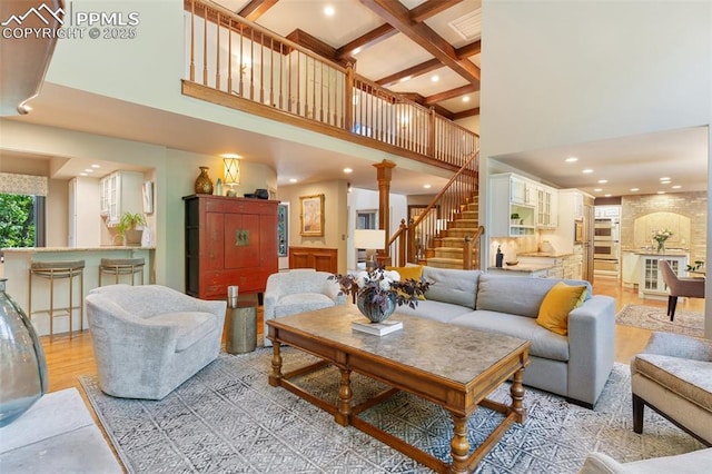 155 Grayson Ct, Colorado Springs, CO 80906 - living area featuring a towering ceiling, stairs, beam ceiling, light wood-type flooring, and recessed lighting