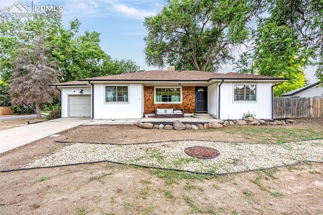 601 N 15th St, Canon City, CO 81212 - ranch-style house with an attached garage, concrete driveway, an outdoor hangout area, and a porch