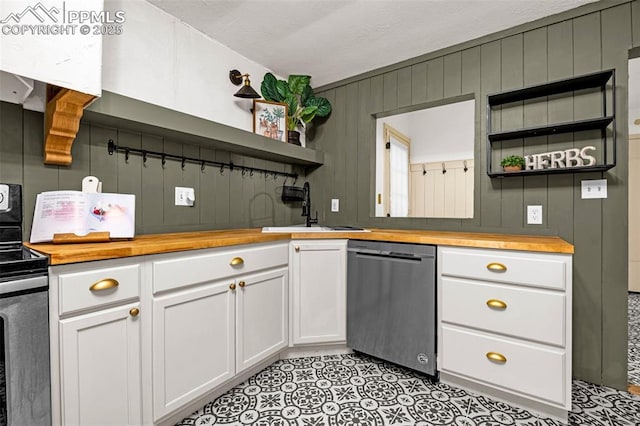 601 N 15th St, Canon City, CO 81212 - kitchen with open shelves, stainless steel appliances, butcher block countertops, white cabinetry, and wood walls