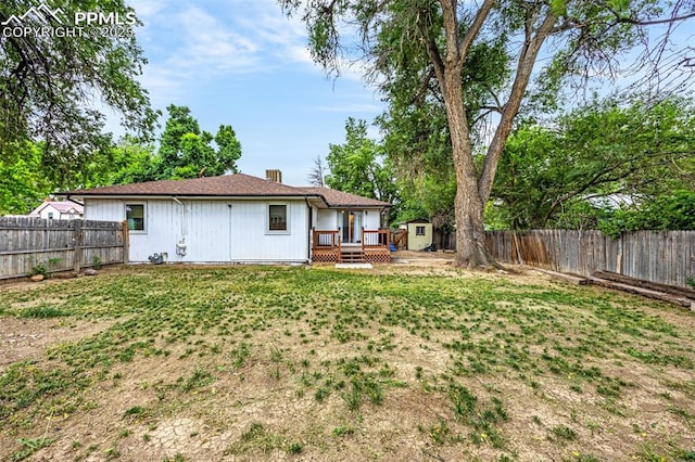 601 N 15th St, Canon City, CO 81212 - rear view of house with a deck, a fenced backyard, and a storage shed