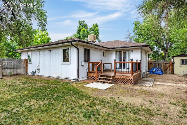 601 N 15th St, Canon City, CO 81212 - rear view of property featuring a fenced backyard, a deck, and an outdoor structure