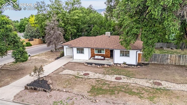 601 N 15th St, Canon City, CO 81212 - view of front of house featuring concrete driveway, a patio, and an attached garage