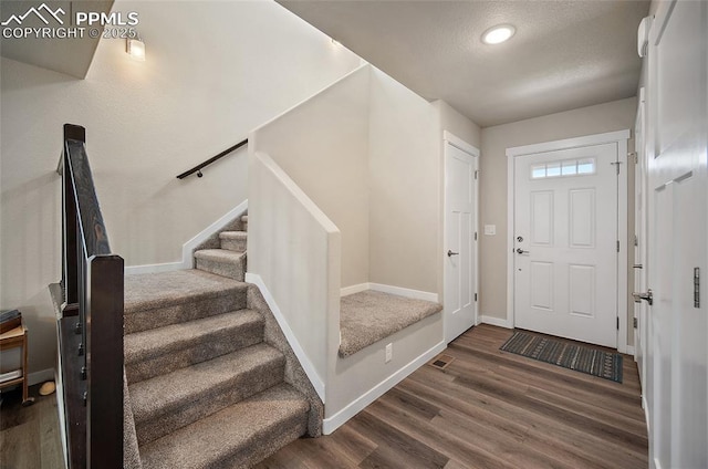 4928 Wolf Moon Dr, Colorado Springs, CO 80911 - foyer entrance with wood finished floors, stairs, a textured ceiling, and recessed lighting