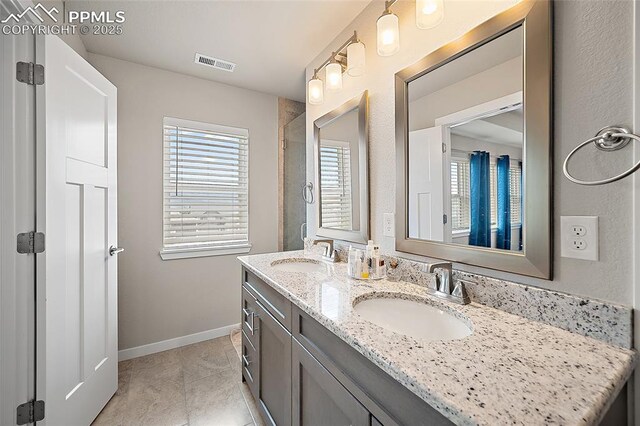 4928 Wolf Moon Dr, Colorado Springs, CO 80911 - bathroom featuring double vanity and tile patterned floors