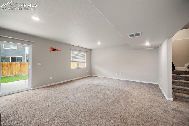 4928 Wolf Moon Dr, Colorado Springs, CO 80911 - empty room featuring carpet floors, stairway, recessed lighting, and a textured ceiling