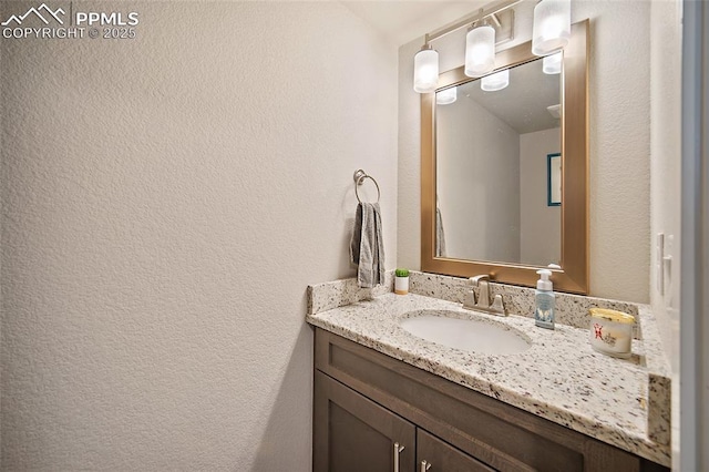 4928 Wolf Moon Dr, Colorado Springs, CO 80911 - bathroom with vanity and a textured wall