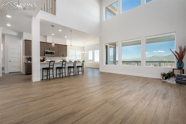17226 Alsike Clover Ct, Monument, CO 80132 - living area with light wood-style floors, a high ceiling, and recessed lighting