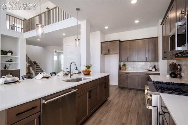 17226 Alsike Clover Ct, Monument, CO 80132 - kitchen featuring appliances with stainless steel finishes, light countertops, wood finished floors, hanging light fixtures, and recessed lighting