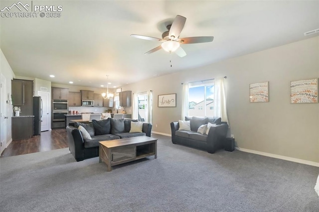 4631 Zircon Dr, Colorado Springs, CO 80938 - living room featuring dark carpet, a ceiling fan, recessed lighting, and a chandelier