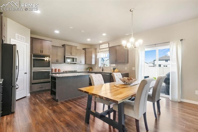 4631 Zircon Dr, Colorado Springs, CO 80938 - dining area featuring dark wood-type flooring, a chandelier, and recessed lighting