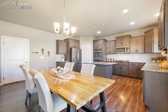 4631 Zircon Dr, Colorado Springs, CO 80938 - dining area with dark wood-style floors, a chandelier, and recessed lighting