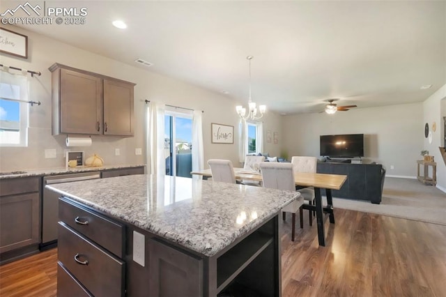 4631 Zircon Dr, Colorado Springs, CO 80938 - kitchen featuring stainless steel dishwasher, a chandelier, a kitchen island, and wood finished floors