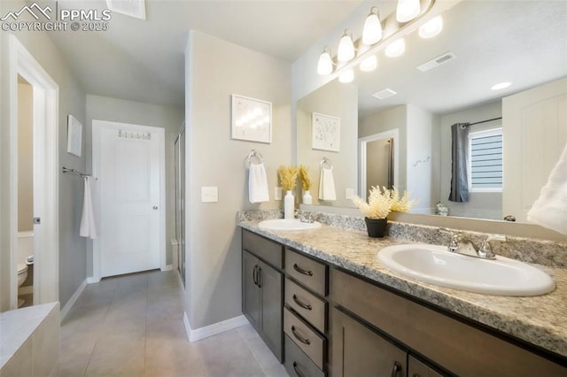 4631 Zircon Dr, Colorado Springs, CO 80938 - full bath featuring double vanity, tile patterned floors, and a stall shower