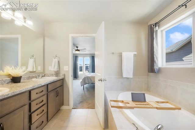 4631 Zircon Dr, Colorado Springs, CO 80938 - ensuite bathroom featuring double vanity, a bath, ceiling fan, and tile patterned flooring