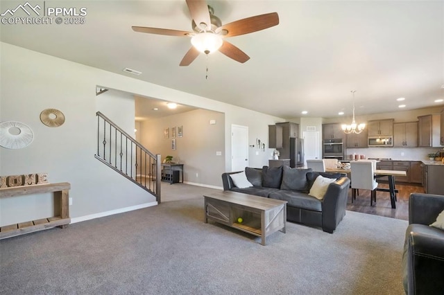 4631 Zircon Dr, Colorado Springs, CO 80938 - carpeted living area with stairway, ceiling fan, a chandelier, and recessed lighting