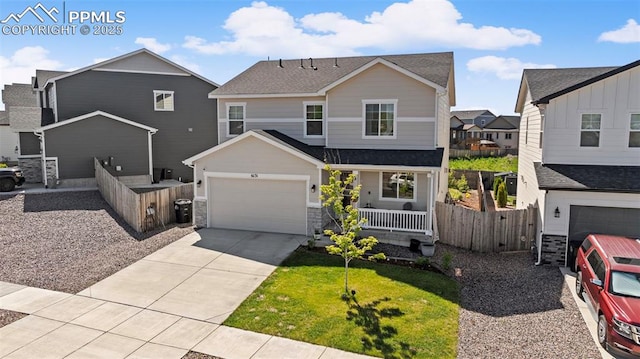 6131 Vickie Ln, Colorado Springs, CO 80923 - view of front of home with a porch, driveway, stone siding, and roof with shingles