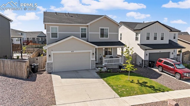 6131 Vickie Ln, Colorado Springs, CO 80923 - view of front of property with a porch, driveway, stone siding, a residential view, and an attached garage