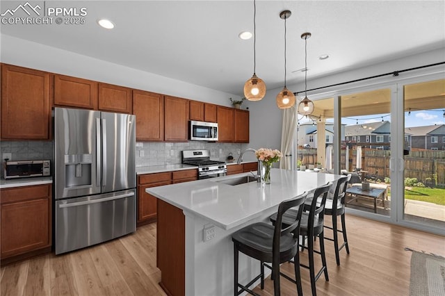 6131 Vickie Ln, Colorado Springs, CO 80923 - kitchen featuring stainless steel appliances, light countertops, decorative backsplash, light wood-style floors, and recessed lighting