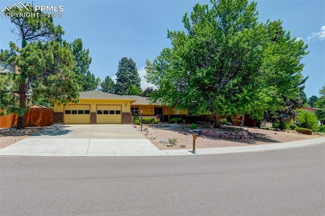 3710 Saddle Rock Rd, Colorado Springs, CO 80918 - view of front of house with an attached garage and concrete driveway