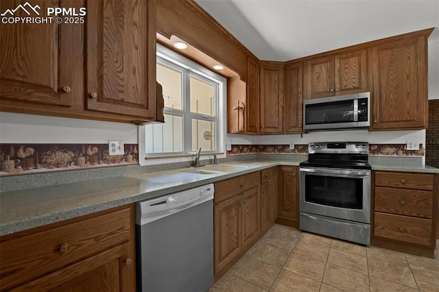 3710 Saddle Rock Rd, Colorado Springs, CO 80918 - kitchen featuring appliances with stainless steel finishes, brown cabinetry, and light tile patterned flooring