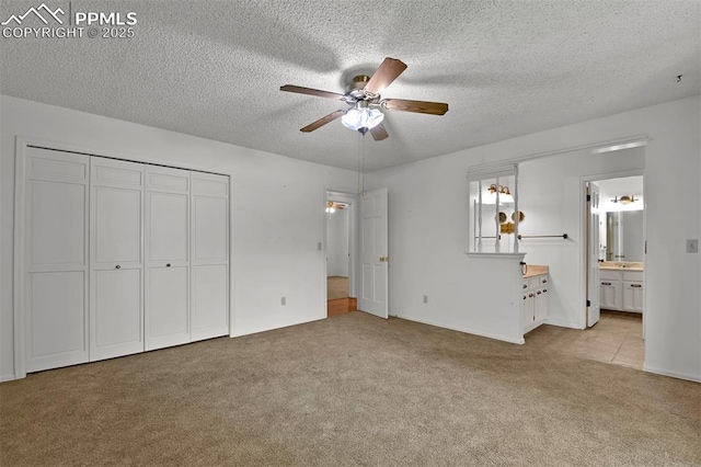 3710 Saddle Rock Rd, Colorado Springs, CO 80918 - unfurnished bedroom featuring carpet floors, a textured ceiling, ceiling fan, a closet, and connected bathroom