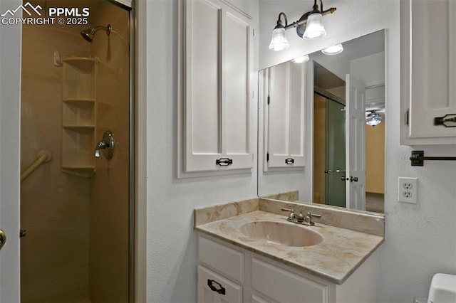 3710 Saddle Rock Rd, Colorado Springs, CO 80918 - bathroom with a shower stall, vanity, and a textured wall