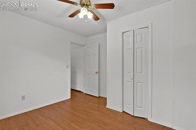 3710 Saddle Rock Rd, Colorado Springs, CO 80918 - unfurnished bedroom featuring a textured ceiling, wood finished floors, a ceiling fan, a closet, and a baseboard heating unit
