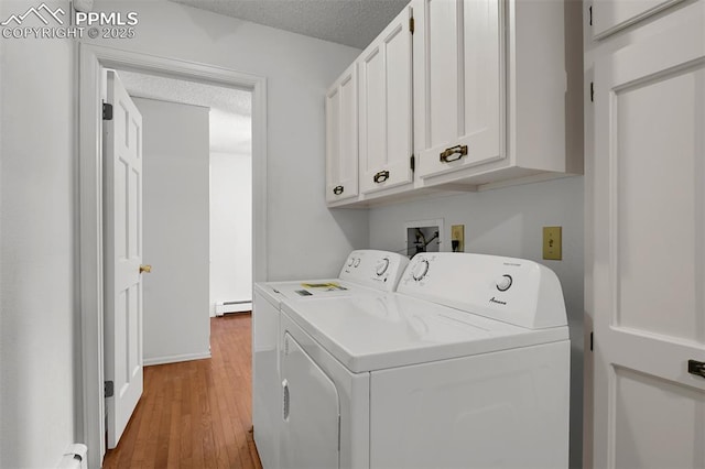 3710 Saddle Rock Rd, Colorado Springs, CO 80918 - washroom featuring independent washer and dryer, a baseboard radiator, cabinet space, wood finished floors, and a textured ceiling