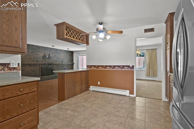 3710 Saddle Rock Rd, Colorado Springs, CO 80918 - kitchen featuring a baseboard radiator, freestanding refrigerator, plenty of natural light, ceiling fan, and wainscoting