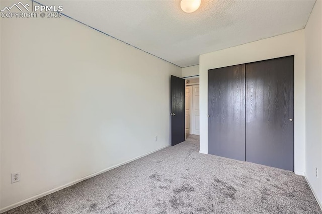 1994 Erin Loop, Colorado Springs, CO 80918 - unfurnished bedroom featuring carpet floors, a closet, and a textured ceiling