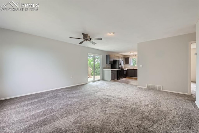 1994 Erin Loop, Colorado Springs, CO 80918 - unfurnished living room featuring a ceiling fan and light colored carpet