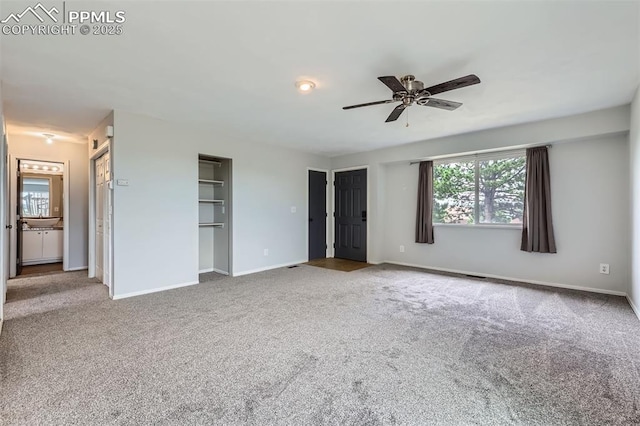 1994 Erin Loop, Colorado Springs, CO 80918 - unfurnished bedroom featuring multiple windows, carpet, and multiple closets