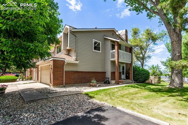 12183 W Chenango Dr, Morrison, CO 80465 - view of front of house featuring a balcony, a garage, brick siding, a front yard, and a chimney