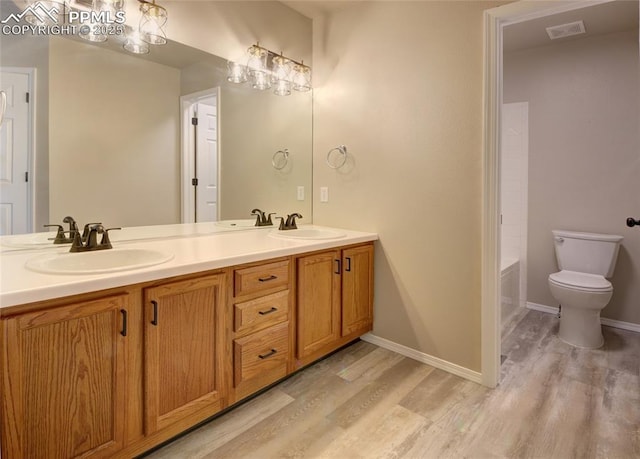 6872 Los Reyes Cir, Colorado Springs, CO 80918 - full bathroom with wood finished floors and double vanity