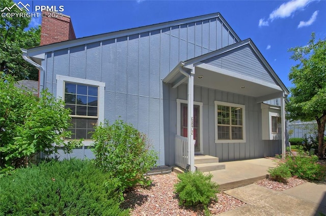 6872 Los Reyes Cir, Colorado Springs, CO 80918 - view of front of house with a chimney and board and batten siding