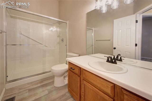 6872 Los Reyes Cir, Colorado Springs, CO 80918 - bathroom with a stall shower, wood finished floors, and vanity