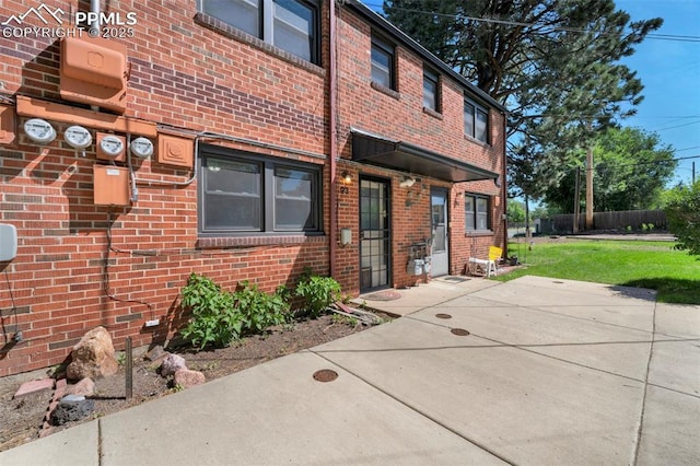 2493 Paseo Rd, Colorado Springs, CO 80907 - view of front facade featuring brick siding and a patio area
