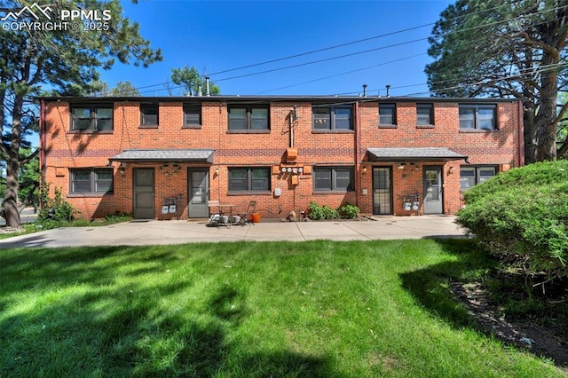 2493 Paseo Rd, Colorado Springs, CO 80907 - rear view of property featuring a yard and brick siding