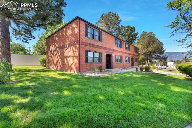 2493 Paseo Rd, Colorado Springs, CO 80907 - back of house featuring brick siding and a yard