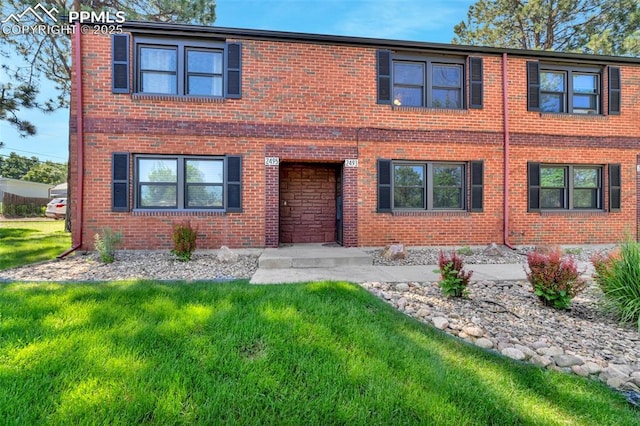 2493 Paseo Rd, Colorado Springs, CO 80907 - view of front of property featuring brick siding and a front yard