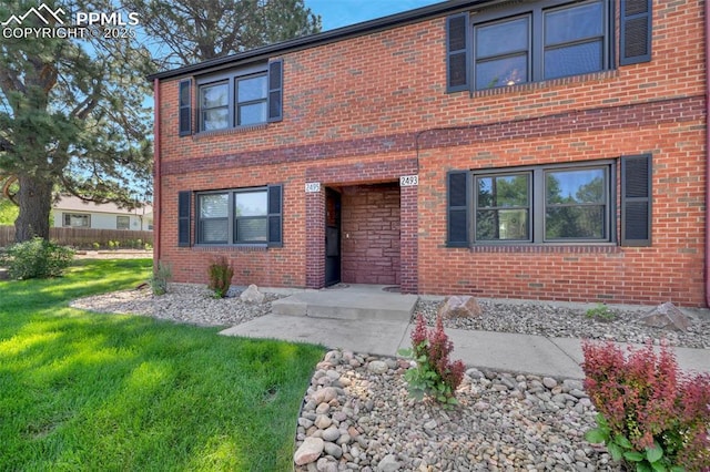 2493 Paseo Rd, Colorado Springs, CO 80907 - view of front of property featuring brick siding and a front yard