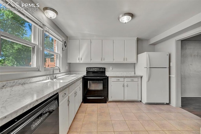 2493 Paseo Rd, Colorado Springs, CO 80907 - kitchen with black appliances, white cabinetry, light tile patterned flooring, and light stone countertops