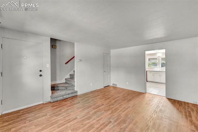 2493 Paseo Rd, Colorado Springs, CO 80907 - spare room featuring light wood-style floors and stairs