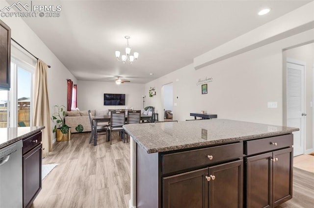 2823 Gobi Dr, Colorado Springs, CO 80939 - kitchen with stainless steel dishwasher, light wood-type flooring, a chandelier, light stone counters, and dark brown cabinets