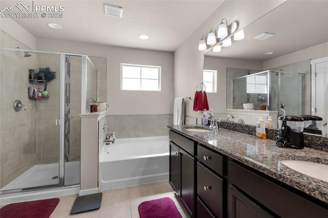 2823 Gobi Dr, Colorado Springs, CO 80939 - full bath with tile patterned floors, a bath, a stall shower, double vanity, and recessed lighting