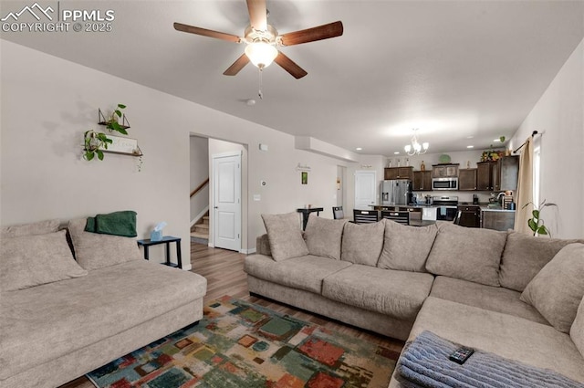 2823 Gobi Dr, Colorado Springs, CO 80939 - living area featuring a chandelier, wood finished floors, stairway, a ceiling fan, and recessed lighting