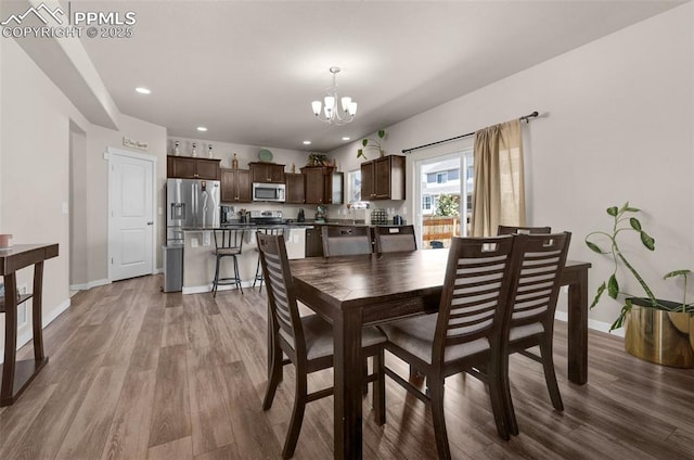 2823 Gobi Dr, Colorado Springs, CO 80939 - dining area with a chandelier, wood finished floors, and recessed lighting